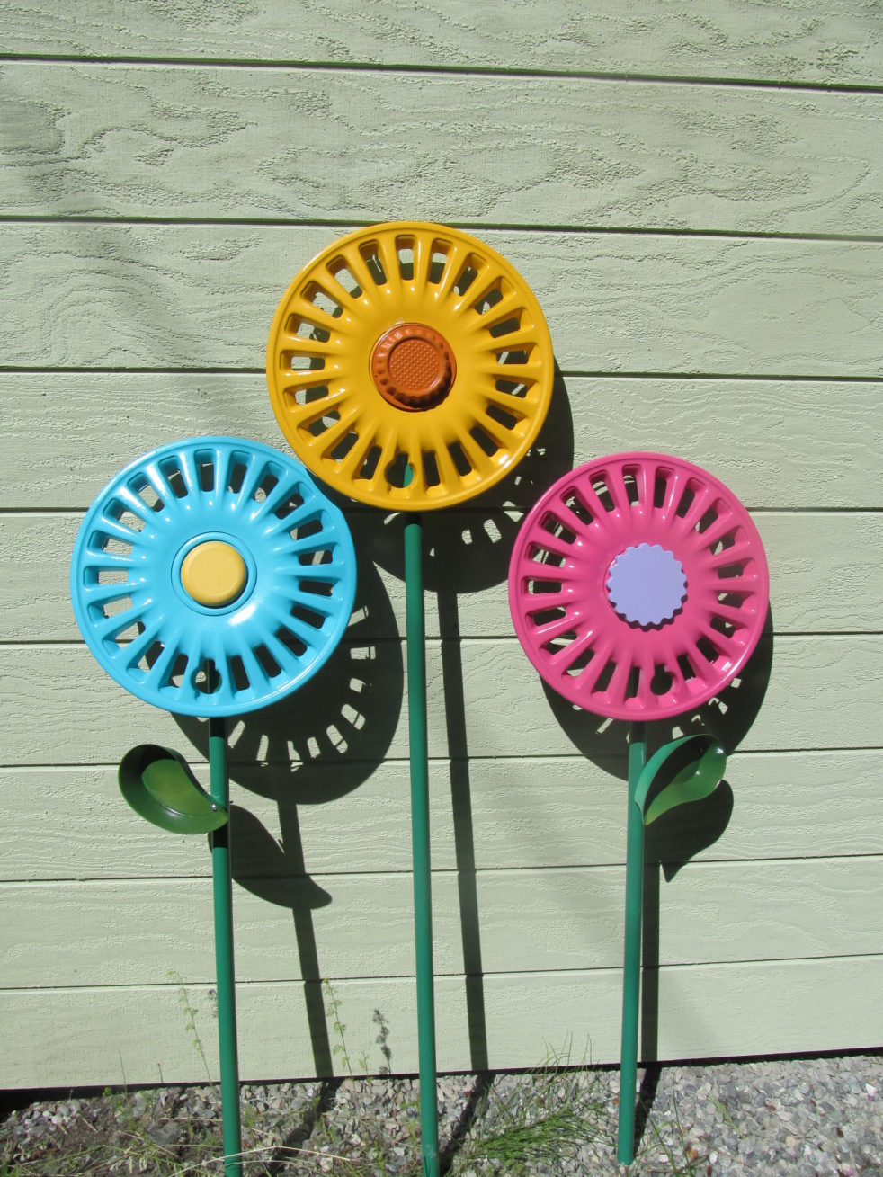 happy hub cap flowers by shed