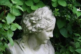 close up of the face of a statue depicting a Greek young lady, used in the garden