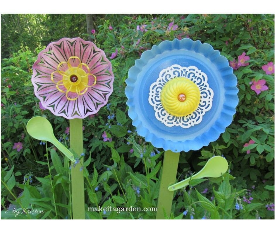 Easy garden crafts: photo of a cake pan spray-painted to look like a flower. It is screwed to a wood stake and put out in the garden as decor 