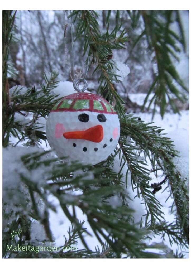 Tree ornament snowman face made from a golf ball