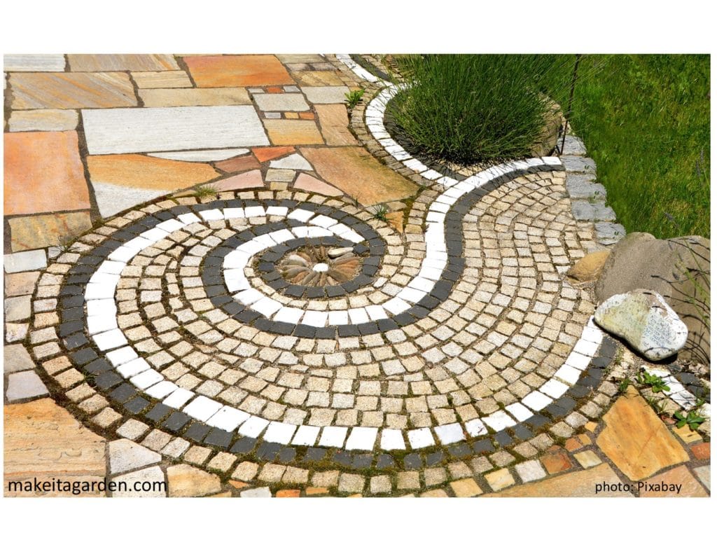 close up photo of different shapes, colors and styles of brick all put together to make a concrete patio or walkway. Its creative and interesting.
