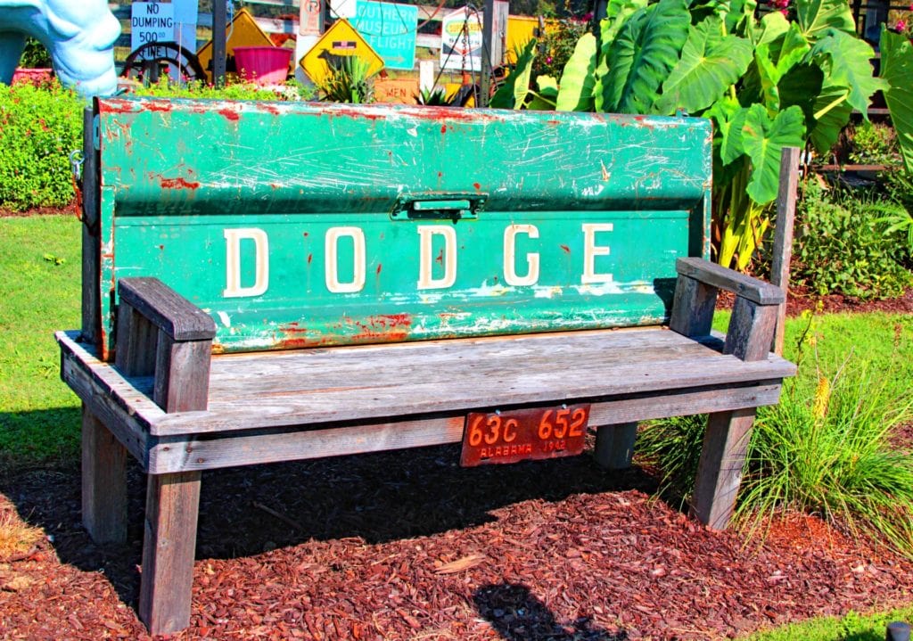 garden theme is flea market. Photo of a wooden bench made from the tail gate of a Dodge pick-up truck