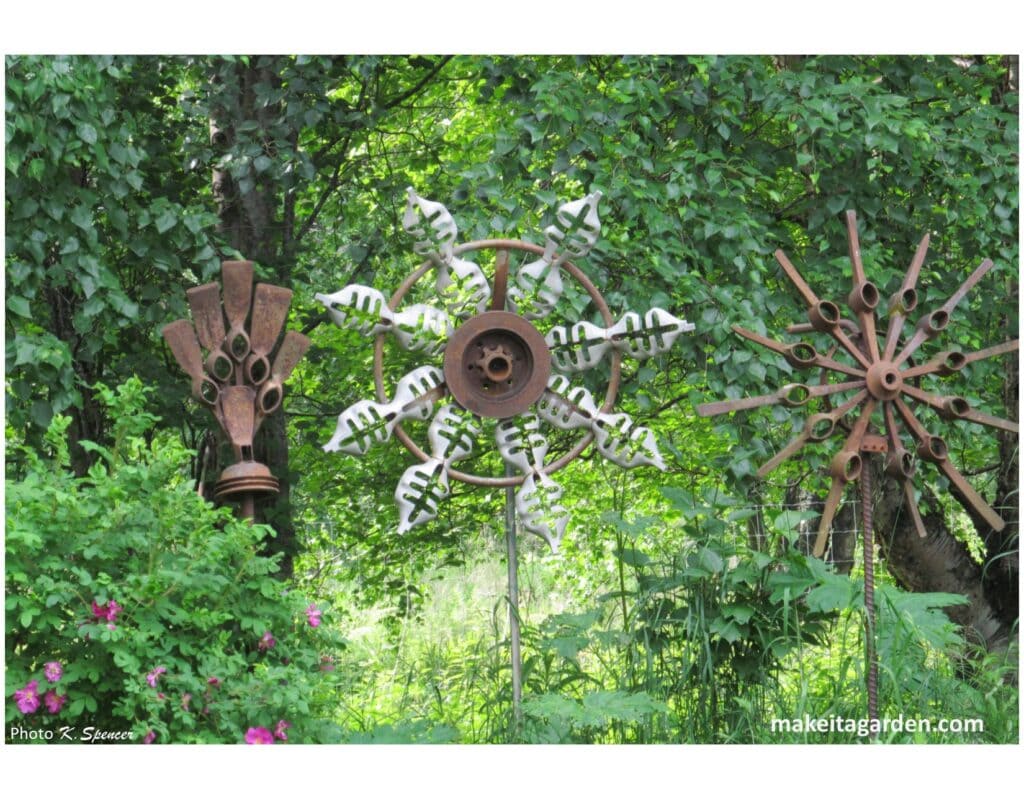 3 large rusty metal flower sculptures. Imaginative sculptures make Palmer Garden