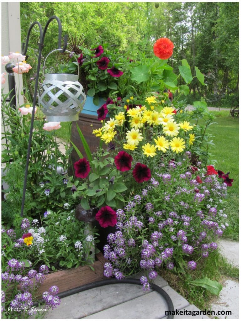 photo of grouping of flower pots with a variety of different colors of flowers. Imaginative sculptures make Palmer garden