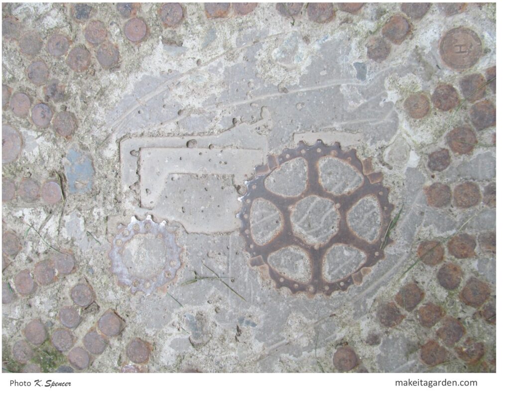 Close up image of a tractor imprint in concrete stepping stone