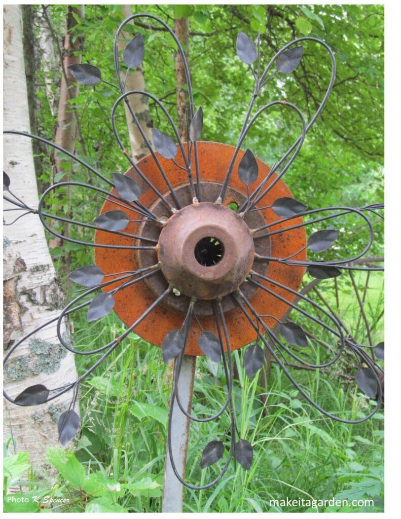 Close up of a metal flower sculpture in the garden. Imaginative sculptures make Palmer Garden
