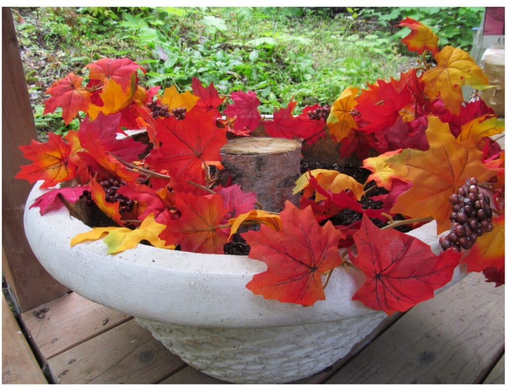 Planter with fall leaves added. Decor for pretty Fall porch