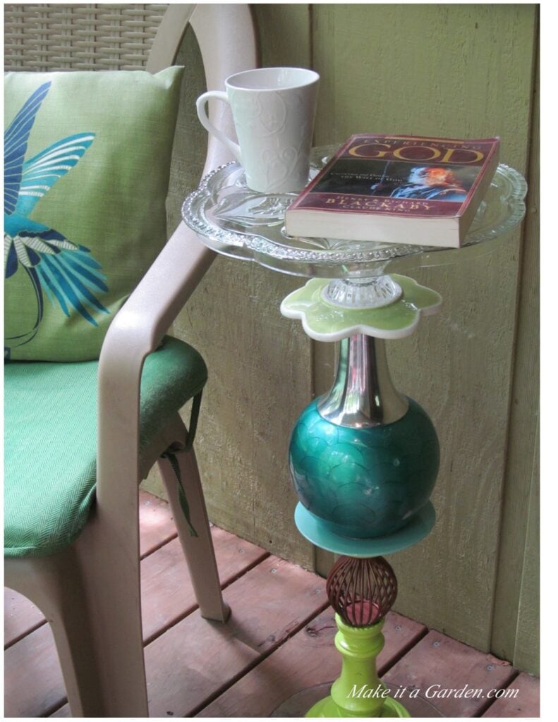 re-purpose a glass platter. Photo of table made with glass platter used as a little side table on thee porch for coffee cup and book.
