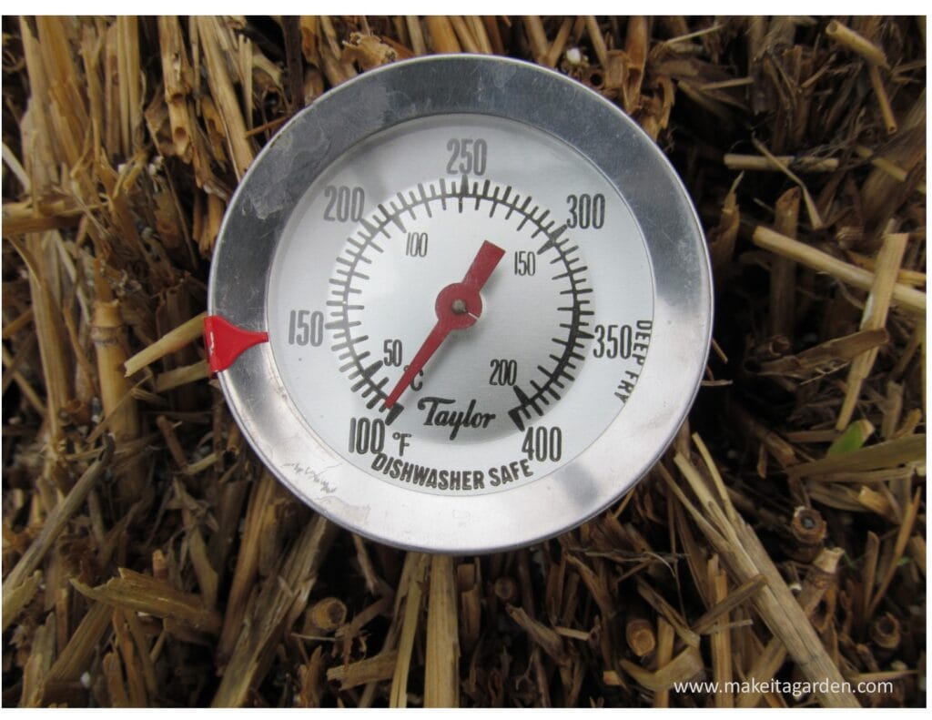 close up photo of a thermometer showing 105 degrees placed in the strawbale to know the temperature as it heats up in the preparation process