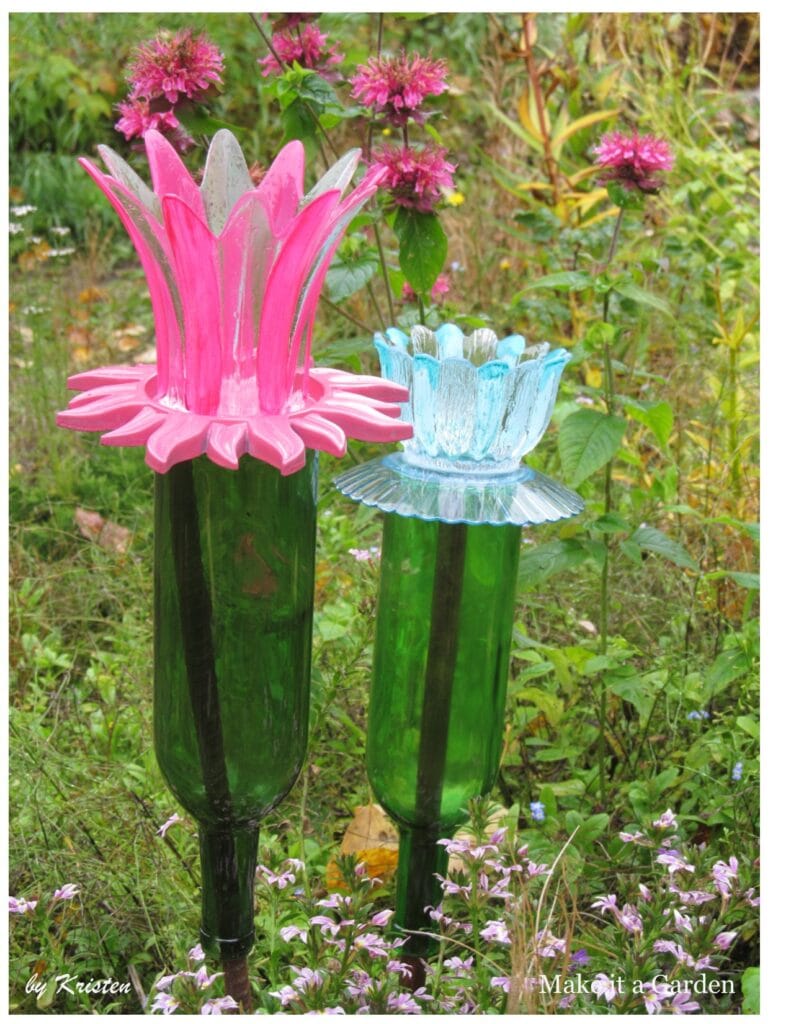 2 wine bottle flowers on garden stakes in a meadow of flowers