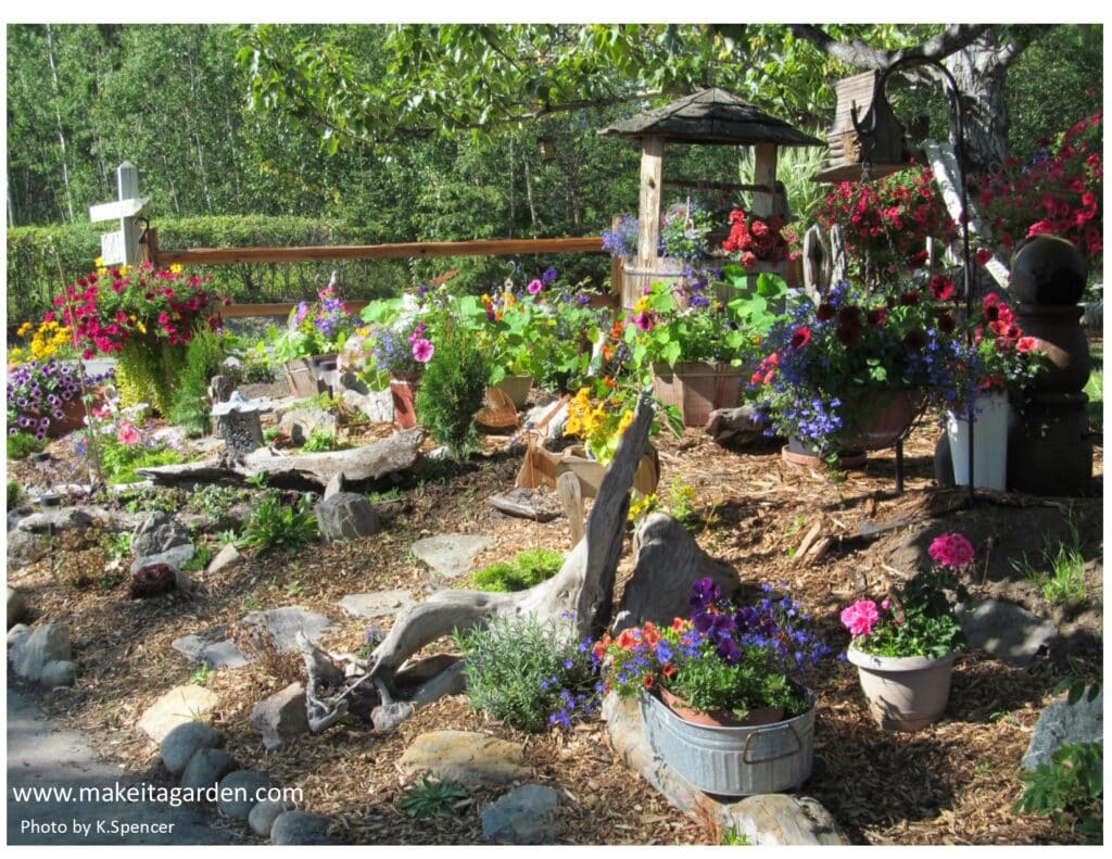 Dazzling flower garden. A wide view of the expansive garden as seen from the street. Baskets of flowers everywhere and pieces of driftwood and stones as accents.