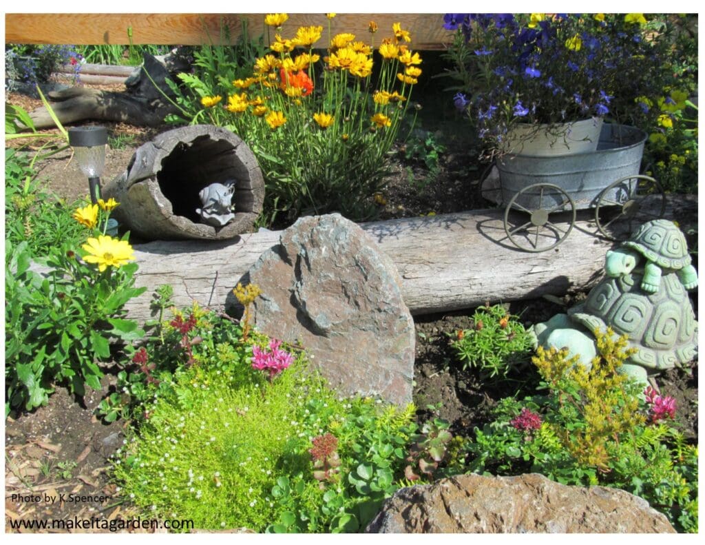 Dazzling flower garden. A big rock and a long, hollowed out log are in the garden surrounded by flowers and garden decor
