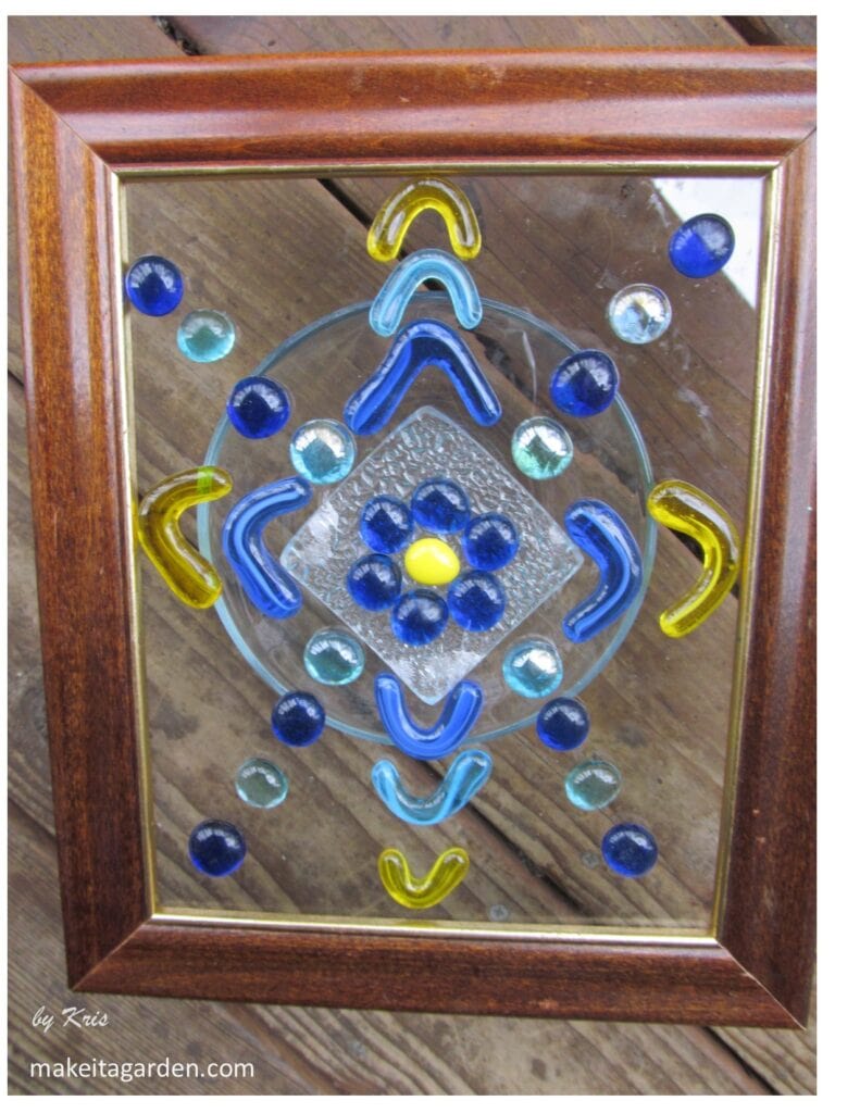 Example 1 of a glass bead artwork glued to surface of glass in a photo frame. 