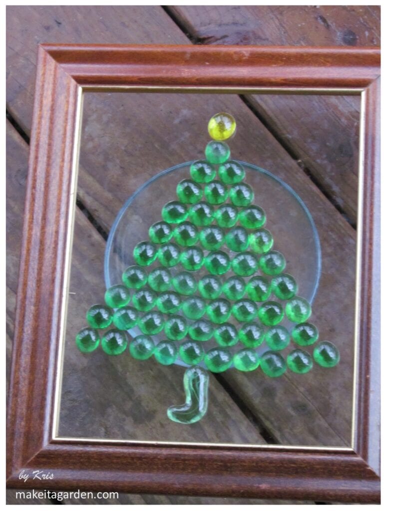 Example 3 of a glass bead artwork glued to surface of glass in the shape of a Christmas Tree 