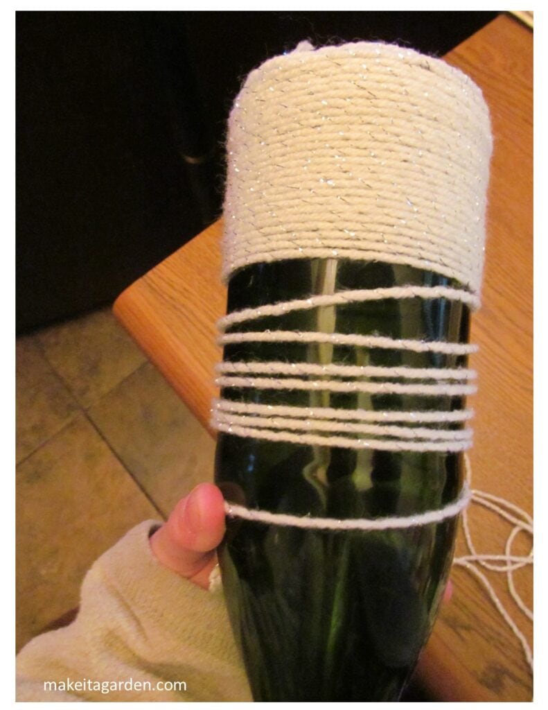 The bottle is half-way wrapped with yarn nice and neatly and quickly
