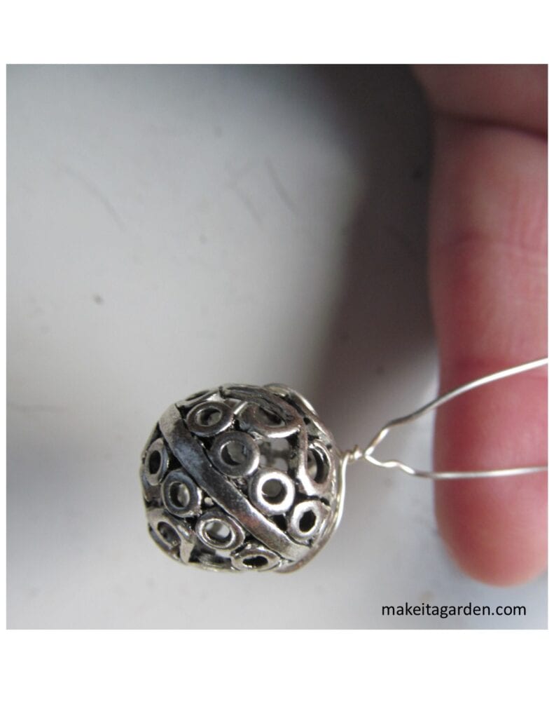 A round slider jewelry piece with wires through it to make a stamen piece for a different dish flower garden art.

