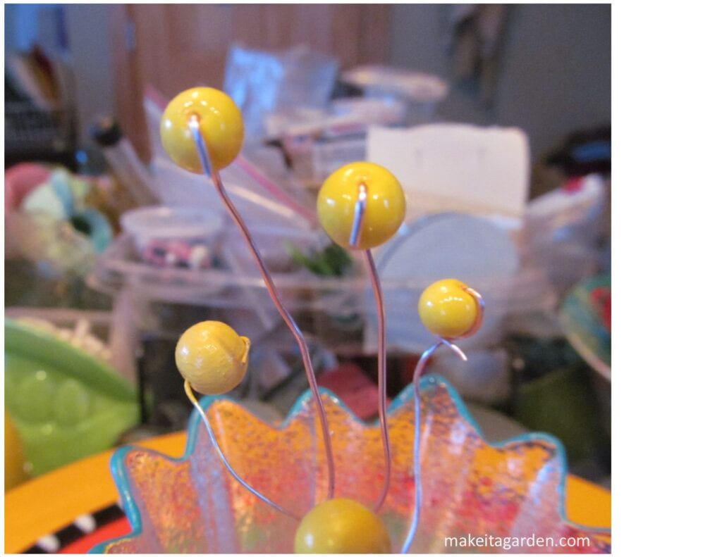 New dish flower design. Shows how to attach the beads to the end of the wire for making the stamen centerpiece.