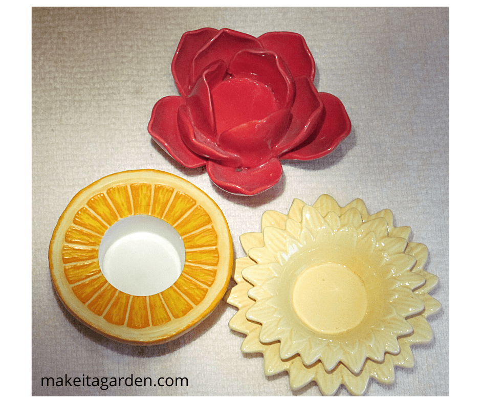 Group of 3. example of decorative ceramic votive candle holders that make cute center pieces. One is like an orange cut in half. One looks like rose. One looks like a daisy