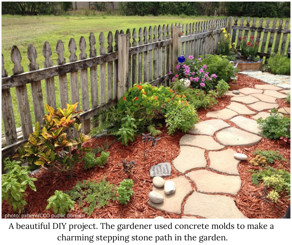 Garden path ideas. Stepping stone pathway thru a little flower garden with a wood fence
