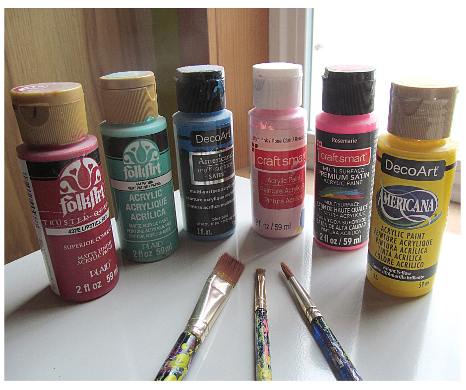 a grouping of craft paints different colors with brushes