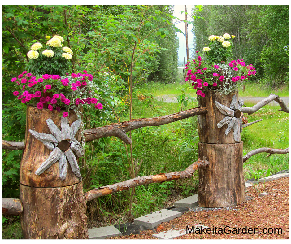 split rail fence made from logs. Bark flower art to embellish. Flower baskets sit on top of logs. One way to improve a wood fence in the backyard