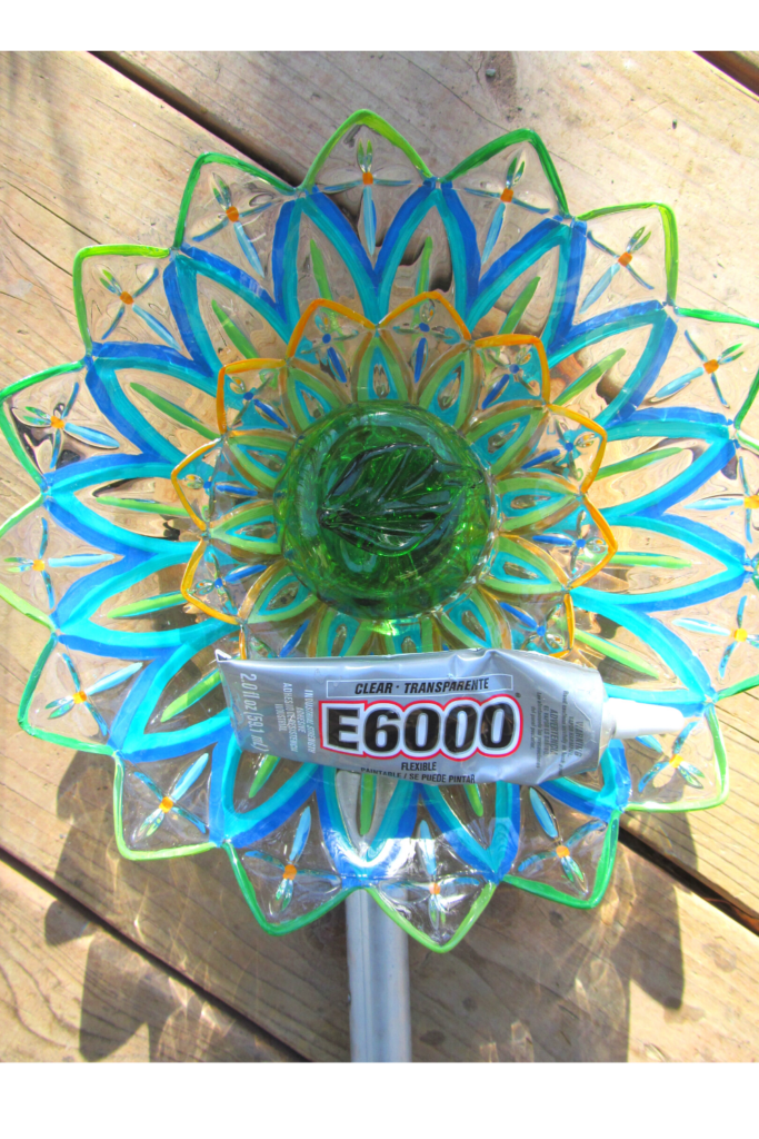 A painted glass dish flower made from pretty floral shaped bowls. E-6000 glue is not always the best choice for garden art.