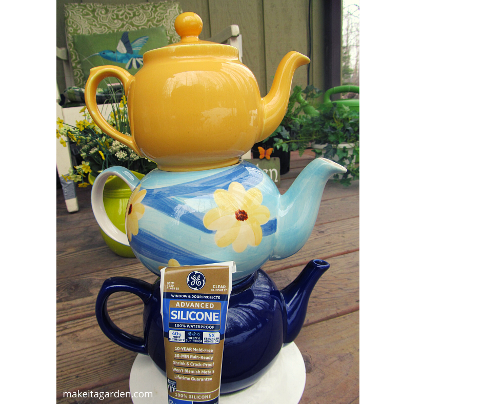 3 colorful teapots stacked one on top of the other, sealed together with silicone, the best glue for garden art