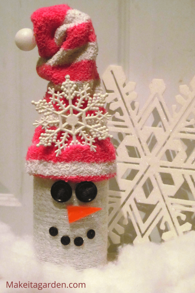 Another way to make a snowman by wrapping the bottle with yarn. A long sock placed over the top of bottle makes the hat.